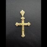 Cruz en oro amarillo con cristo, decorado en las puntas con circonitas