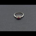 Anillo oro blanco con dos brillantes de 0,04 qtes cada uno y piedra central de color rosa