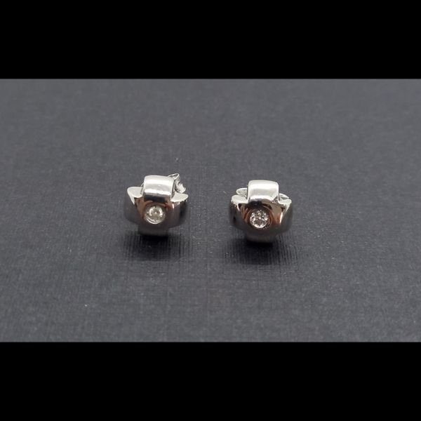 Pendientes oro blanco en forma cruz con brillante central de 0,05qtes