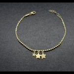 Pulsera de bolitas oro amarillo con colgantes forma estrellas