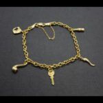 Pulsera oro amarillo 18k con colgante diferentes motivos y cadena de seguridad(17,5 cm)