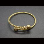Pulsera torneada niña en oro amarillo de 18k con bolas en oro
