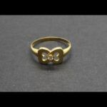 Anillo oro amarillo 18k conforma de lazo con circonita en el centro nº 16