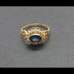 Anillo oro amarillo 18 qt nº 14 con puntas de brillantes y piedra central color azul