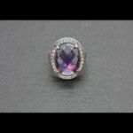 Anillo oro blanco 18k con piedra lila rodeada de circonitas nº 18