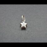 Colgante oro amarillo y blanco de 18k con forma de estrella decorado con circonita