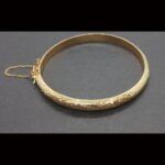 Pulsera oro amarillo 18k tipo caña con cadenita de seguridad