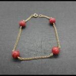 Pulsera oro amarillo 18 qt con bolas rojas (19 cm)