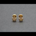 Pendientes oro amarillo 18k con forma de estrella con circonita, cierre de rosca