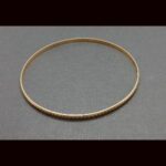 Pulsera oro amarillo 18k tipo aro con rayas