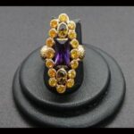 Anillo oro amarillo 18k nº 18 de estilo victoriano con amatista y rodeada de piedras amarillas y verdoso