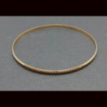 Pulsera oro amarillo 18k tipo aro con rayas